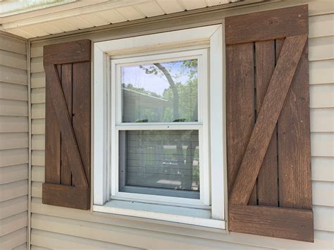 white farmhouse with cedar shutters